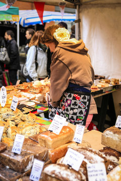 Female market trrader selling breads and pies at the Temple Bar Food Marketin Dublin