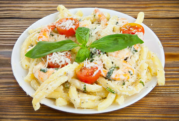 delicious delicious spaghetti with shrimps and basil on  plate