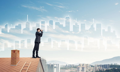 Businessman standing on roof and looking in binoculars. Mixed me