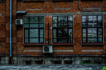 three windows on the brick wall