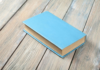 Blue book on wooden table.Education background. Back to school.
