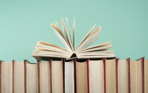 Open book, hardback books on wooden table. Education background. Back to school. Copy space for text.