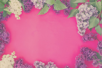 Lilac fresh blue, violet and white flowers on pink background with copy space, retro toned