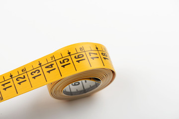 Tape measure yellow on white background. Copy space.