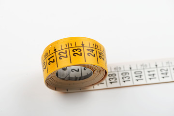 Tape measure white on white background. Copy space. Horizontal shoot.