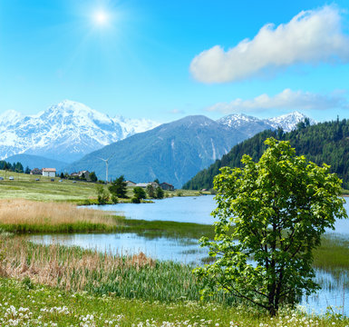 Summer sunshiny mountain landscape with lake (Italy)