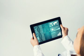 Close of female doctor hands working with tablet pc computer