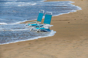 Fototapeta na wymiar Abandoned beach chairs at beach