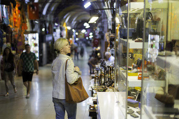 Middle aged woman in storefront shopping in Grand Bazaar,Istanbul