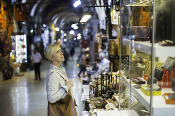 Fototapeta na wymiar Middle aged woman in storefront shopping in Grand Bazaar,Istanbul