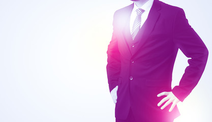 Young businessman standing and thinking