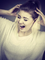 Unhappy woman screaming and yelling in pain