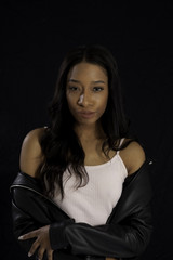 Naklejka premium Pretty Black woman with leather jacket off her shoulder