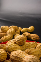 Peanuts in shell on dark background, close up