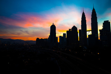 Fototapeta na wymiar A cloudy sunrise in Kuala Lumpur, the capital of Malaysia. Its modern skyline is dominated by the 451m tall KLCC, a pair of glass and steel clad skyscrapers.