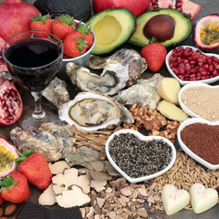 Aphrodisiac love food and drink selection to promote good sexual health forming a background.