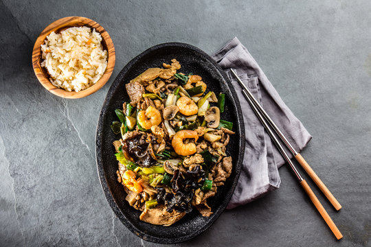 Chinese food. Pan of fried beef, pork, chicken, shiitake mushrooms, prawns and spring onion