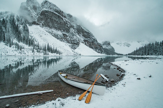 Canoe on lake shore in winter