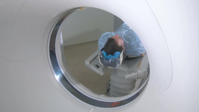 Man being positioned within CT scanner.