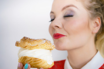 Woman holding cupcake dessert with cream