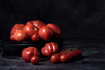 tomatoes  composition on black isolated  background
