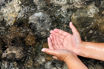  Child scoops up water