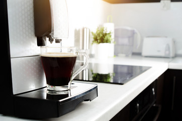 Fototapeta na wymiar Black coffee in glass from coffee maker machine