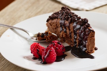 Nice serving of chocolate cheese cake decorated with choloate chips and raspberries. Chocolate...
