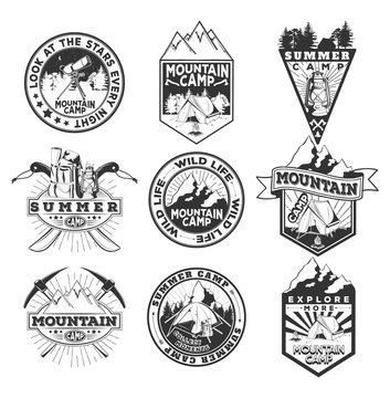 Vector set of black and white badges of mountain and summer camping with a tree texture on a wooden background