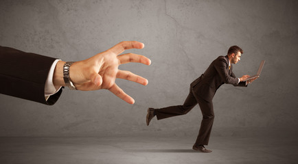 Businessman running from hand