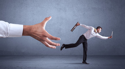 Businessman running from hand
