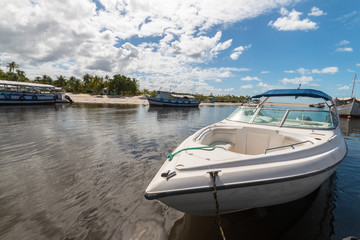 Fototapeta premium Pier on tropical island with boats and motorboats