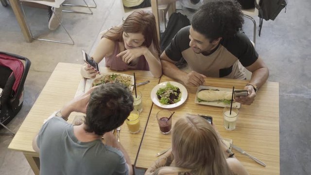 Woman showing smart phone to friends