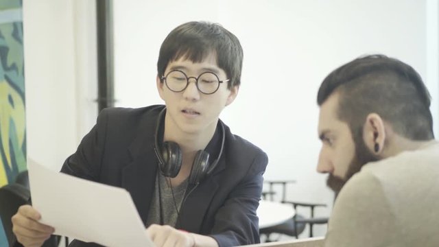 Man showing document to colleague
