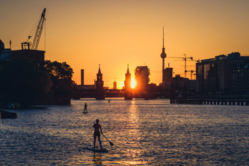 Sunset sky Berlin Panorama - river Spree, Oberbaum Bridge, Tv Tower and stand up paddle board people