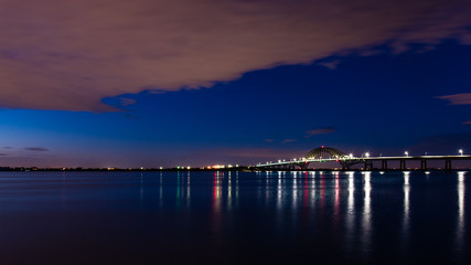 Fototapeta na wymiar Blue Hour, reflections, bridge, water, clouds, lights
