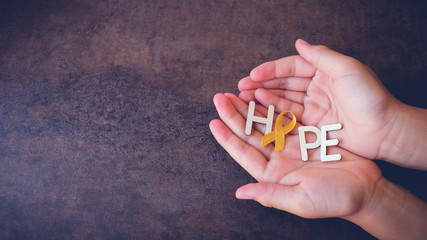Hope with yellow gold ribbons on hands, Sarcoma Awareness, Bone cancer, Liver cancer, Bladder Cancer, childhood cancer awareness, pamoramic banner