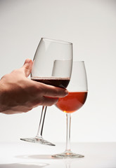 Closeup of hand holding red wine glass