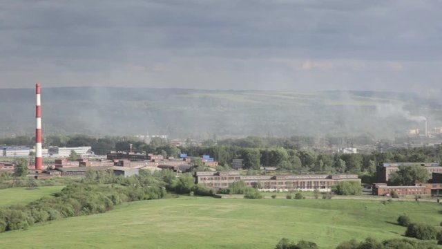 Air pollution above smole city. Pipes throwing smoke towards the city