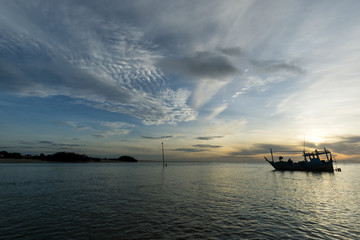 Fototapeta na wymiar Morning light with a fishing boat