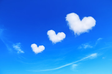 three white heart shaped clouds on blue sky,love concept