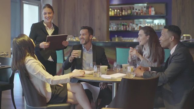 Waitress taking customer order in restaurant
