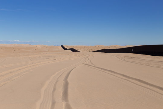 U.S. / Mexico Border Wall Stretching Along Imperial Sand Dunes