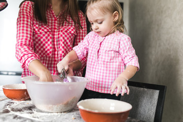 Mom and daughter together in the kitchen