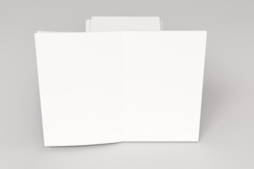 Stack of blank white closed and one open brochure mock-up on white background