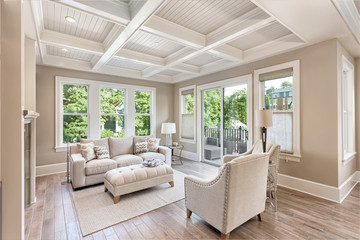 Beautiful living room with hardwood floors in new luxury home. Coffered ceiling adds elegant touch...