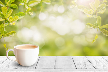 cup of coffee on empty wood table top for display or montage product.
