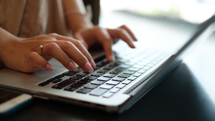 Women's hands typing on computer