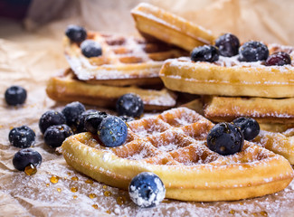 Belgian waffles with blueberries powder and honey 
