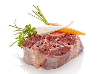 Raw steak with vegetables isolated.